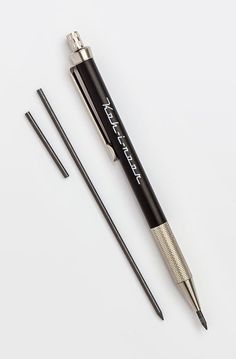 a pen and two needles on a white surface