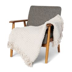 a chair with a blanket on top of it and a wooden frame around the armrests