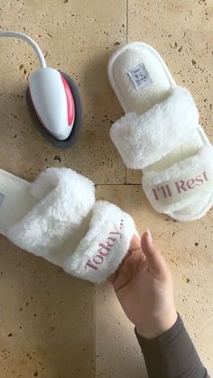 someone is holding up their slippers with the word i'm rest on them