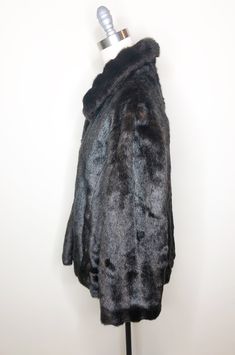 This is a faux fur, reversible jacket by Mackintosh, New England. The fur is soft and cozy and has the look of mink. The buttons look like horn and add a fun vintage flair. The reverse side is brown water resistant fabric, with fur trim. There is some creasing in the reverse fabric (see picture 7) which does not effect wearability. This is a stylish and very practical jacket, ready for whatever Mother Nature has in store. Size tag L. Check measurements carefully. Measurements taken with jacket l Mink Faux Fur Coat With Faux Fur Lining, Mink Colored Faux Fur Coat, Faux Fur Lined Mink Coat, Fall Mink Color Fur Coat With Faux Fur Trim, Vintage Faux Fur Coat For Cold Weather, Vintage Outerwear With Faux Fur Trim, Mink Faux Fur Coat, Brown Water, Peignoir Sets