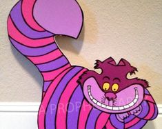 a pink and purple striped cat standing on its hind legs