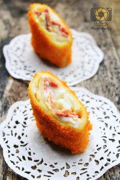 two small pieces of food sitting on top of doily