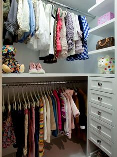 an organized closet with clothes and shoes hanging on the rails, drawers, and shelves