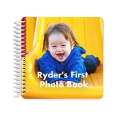 a spiral notebook with a photo of a baby on it and the words ryder's first photo book