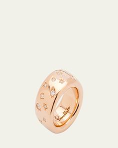 a gold ring with stars and diamonds on the inside, set against a white background