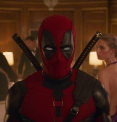 the deadpool character is standing in front of a woman wearing a purple dress and holding two swords