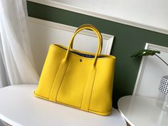 Hermes Garden Party 36 Bag Yellow For Women, Women’s Handbags, Shoulder Bags 14.2in/36cm Rep 1:1 This ingenious, bucolic and elegantly simple bag, is the sporty, casual carryall par excellence. Both town and country canvas, the Garden Party gets out into the country in all seasons. On the sides, the “Clou de selle” snap fasteners help shape the opening of the bag and offer generous space. Bag in Epsom with chevron canvas lining, interior pocket and silver-plated Clou de Selle snap closure. Hermes Garden Party, Simple Bag, Louis Vuitton Shirt, Chanel Shirt, Gucci Gg Marmont, Sporty Casual, Reversible Belt, Luxury Products, Snap Fasteners