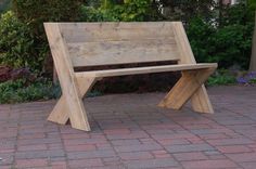 a wooden bench sitting on top of a brick walkway