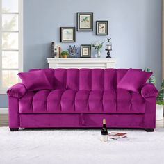 a purple couch sitting on top of a white rug