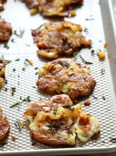 some food is sitting on a baking sheet and ready to be cooked in the oven