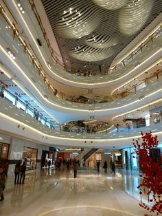 the interior of a shopping mall with people walking around