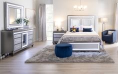 a bedroom with white furniture and blue accents