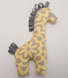 a giraffe stuffed animal sitting on top of a white wall