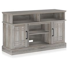 a large entertainment center with two doors and shelves on one side, in grey wood