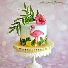 a cake decorated with flowers and a pink flamingo