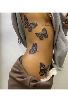 a woman's stomach with butterflies on it and the bottom part of her belly