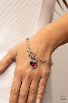 Bordered in glassy white rhinestones, a pink heart shaped gem sparkles from a toggle closure at the center of an oval silver linked chain for a flirtatious fashion around the wrist. Features a toggle closure. Silver Link Chain, Red Bracelets, Bracelet Online, Jewelry Images, Earring Display, Paparazzi Accessories, Rhinestone Heart, White Rhinestone, Silver Accessories