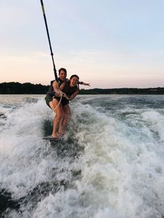 two people on water skis being pulled by a boat