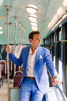 a man in a blue suit standing on a bus