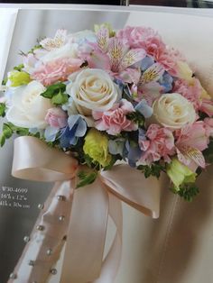 a bouquet of flowers sitting on top of a white chair