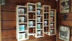 a wooden shelf filled with cups and mugs