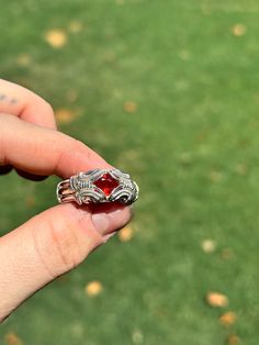 Vibrant Orange Spessertite garnet set in sterling silver wire. Size 10 US :) Handmade Sterling Silver Ruby Ring, Handmade Ruby Ring In Sterling Silver, Red Sapphire Birthstone Ring In Sterling Silver, Unique Silver Ruby Birthstone Ring, Unique Silver Ruby Ring With Birthstone, Garnet Gemstone Open Ring Jewelry, Heirloom Garnet Gemstone Jewelry, Silver Garnet Birthstone Ring With Accent Stones, Sterling Silver Ruby Ring In White Gold