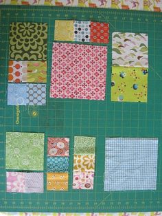 a green cutting board topped with lots of different types of quilts