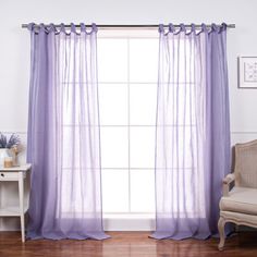 purple sheer curtains hanging in front of a window