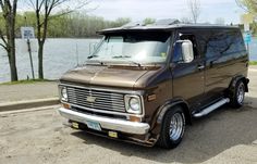 an old van is parked by the water