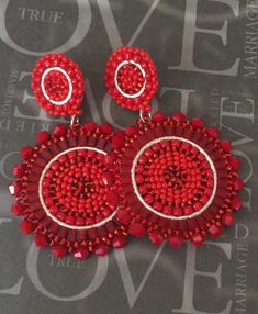 Bright red beaded disc post earrings. If you like to receive compliments on your jewelry, you will love these gorgeous earrings. I created these stunning earrings with beautiful shades of Red 11/0 seed beads and over fifty velvety red genuine crystal beads. Each bead is individually and expertly woven to make these beautiful earrings. The post earwires are hypo allergenic and the findings and center hoop is silver plated. These luxurious earrings measure approximately 2.75 inches total. Stunning Cheap Red Circular Earrings, Cheap Red Statement Beaded Earrings, Cheap Red Crafted Beaded Earrings, Cheap Red Beaded Earrings For Party, Cheap Red Beaded Earrings, Cheap Red Bohemian Beaded Earrings, Red Goddess, Luxurious Earrings, Goddess Earrings