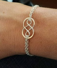 "Wear this bracelet as a reminder of an infinite connection. This sterling silver double infinity charm bracelet can be customized with one or more initials. It is the perfect bracelet to wear everyday. This pierce can also be worn as an ankle bracelet.  **Please indicate the font and initials you would like. The initials come without darkening. If you would like the initials darkened, please indicate in notes to seller. *To find your bracelet size, measure your wrist and  add 1/2 an inch.  **To Sterling Silver Infinity Bracelets With Adjustable Chain, Adjustable Silver Infinity Chain Bracelet, Silver Infinity Chain Bracelet As Gift, Sterling Silver Infinity Bracelet With Adjustable Chain, Silver Infinity Chain Bracelet Gift, Godmother Bracelet, Infinity Anklet, Infinity Charm Bracelet, Mom Jewelry Personalized