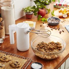 cookie ingredients being made in a bowl on a kitchen counter with other baking supplies and utensils