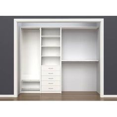 an empty white closet with drawers and shelves