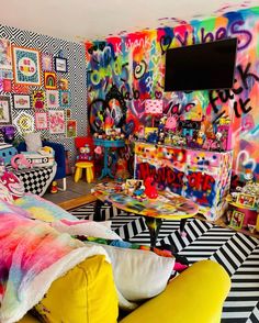 a brightly colored bedroom with lots of graffiti on the walls