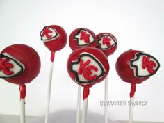 red and white cake pops with the letter k on them