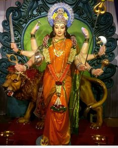 a statue of the hindu goddess in front of a lion