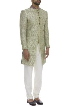 Giving your wedding-ready collection a royal and luxe appeal is this soothing hued bead embroidered sherwani. Flaunts of side slits, style this attire with gold churidaar and khussa juttis to sport a class apart traditional look.
bead embroidery
side slits
mandarin collar
full sleeves
cutdana embroidery - Aza Fashions Elegant Raw Silk Bandhgala For Reception, Naqshi Bandhgala In Jamawar For Reception, Elegant Raw Silk Nehru Jacket For Reception, Elegant Raw Silk Sherwani For Reception, Formal Pista Green Sets With Chikankari Embroidery, Elegant Pista Green Sherwani For Formal Occasions, Formal Fitted Pista Green Sherwani, Reception Sherwani With Chikankari Embroidery In Raw Silk, Reception Nehru Jacket With Chikankari Embroidery