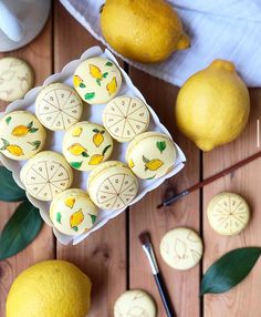 there are lemons on the table next to some cookies