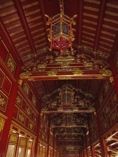 the inside of a building with red and gold decorations