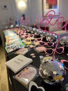 the table is set up with pink and silver decorations