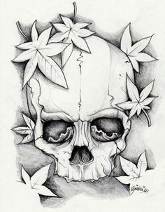 a drawing of a skull with leaves around it