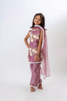 Girls Lavender Stunning Kurta & Printed Trouser With Dupatta  The kurta is beautifully crafted with intricate printed motifs on the front panel. It features a straight-cut silhouette that offers a modern yet traditional vibe, ideal for festive occasions or casual wear. The neckline is a classic round  often adorned with delicate lace or piping detailing. The matching printed trousers complement the kurta with their vibrant, playful patterns. The trouser fit is tailored but comfortable, often fea Purple Floral Print Sets For Eid, Summer Festive Purple Sets, Purple Sets With Printed Motifs For Diwali, Diwali Purple Sets With Printed Motifs, Boys Kurta, Goddess Dress, Kundan Earrings, Printed Trousers, Finger Rings