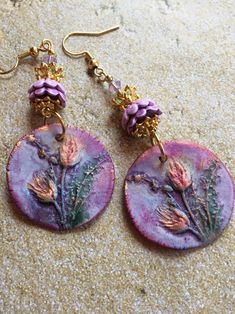 These Ceramic Earrings are made with charms made by an artisan.  The earrings are accented with ceramic and metal flower bead caps and Swarovski crystals Bohemian Hand Painted Dangle Flower Earrings, Bohemian Hand Painted Purple Earrings, Purple Hand Painted Bohemian Earrings, Handmade Nature-inspired Hoop Earrings Gift, Handmade Nature-inspired Hoop Earrings For Gift, Handmade Nature-inspired Pink Earrings, Handmade Pink Nature-inspired Earrings, Purple Artisan Earrings With Ear Wire, Artisan Flower Earrings For Pierced Ears As Gift