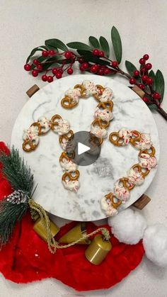 a marble platter with pretzels and christmas decorations