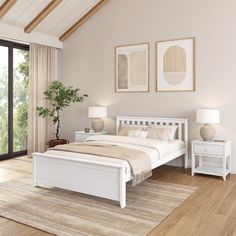 a white bed sitting in a bedroom next to two lamps on either side of the bed