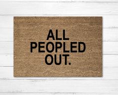 a door mat with the words all people out printed on it in black and white