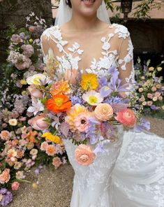 a woman in a wedding dress holding a bouquet of flowers