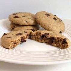 several chocolate chip cookies on a white plate