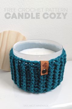 a crocheted candle holder with a button on it