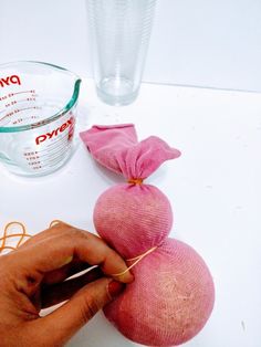 a person is making pink onions on a table